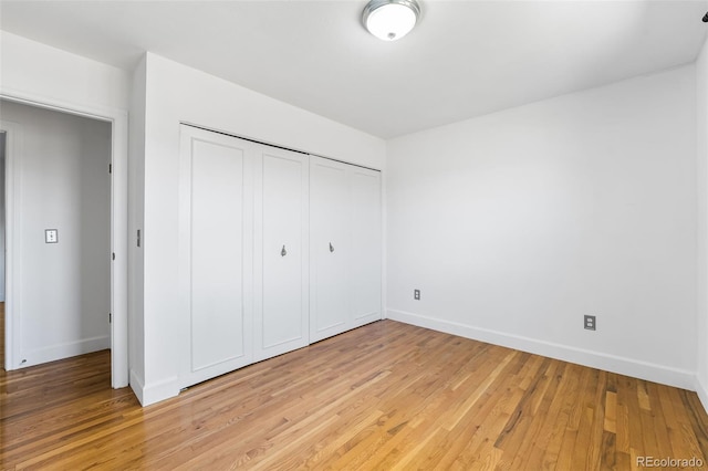 12829 E Nevada Ave, Aurora, CO 80012 - unfurnished bedroom with light wood-type flooring, a closet, and baseboards