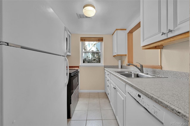 kitchen with white appliances, light tile patterned floors, visible vents, light countertops, and a sink