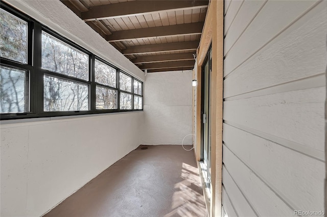 unfurnished sunroom with lofted ceiling with beams and wooden ceiling