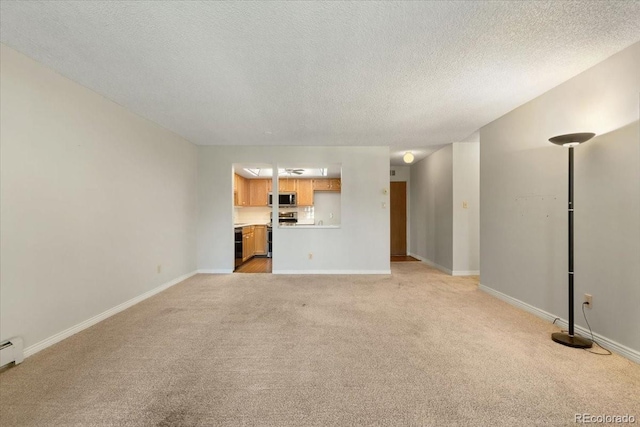 unfurnished living room featuring light colored carpet and a textured ceiling