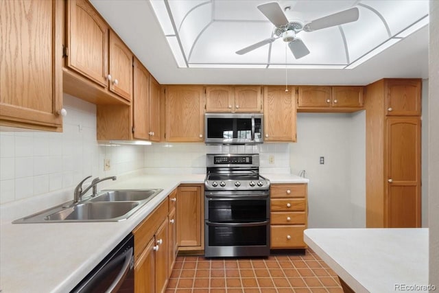 kitchen with backsplash, tile patterned floors, sink, ceiling fan, and appliances with stainless steel finishes