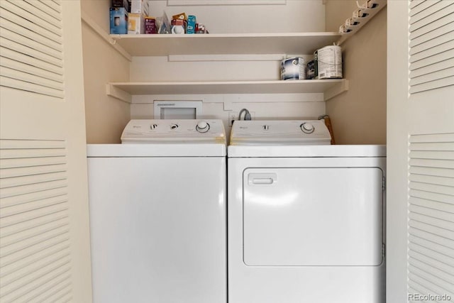 clothes washing area featuring separate washer and dryer