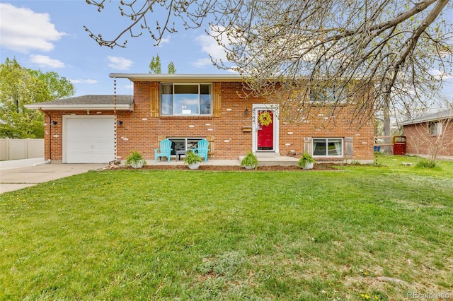 4544 W 65th Ave, Arvada, CO 80003 - raised ranch featuring an attached garage, fence, a front yard, brick siding, and driveway