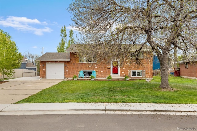 4544 W 65th Ave, Arvada, CO 80003 - view of front of property featuring driveway, brick siding, fence, an attached garage, and a front lawn