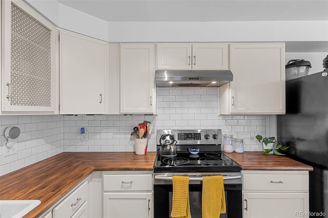 4544 W 65th Ave, Arvada, CO 80003 - kitchen with freestanding refrigerator, stainless steel range with electric stovetop, butcher block counters, and under cabinet range hood