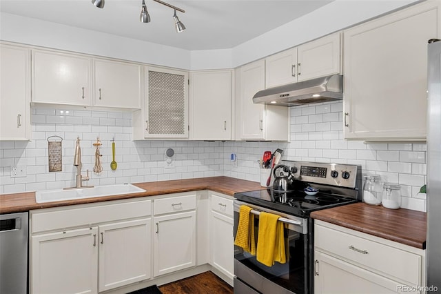 4544 W 65th Ave, Arvada, CO 80003 - kitchen with a sink, wood counters, under cabinet range hood, white cabinets, and appliances with stainless steel finishes