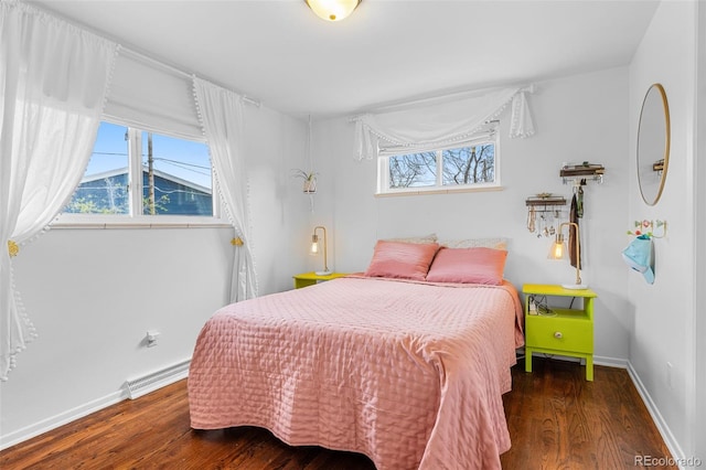 4544 W 65th Ave, Arvada, CO 80003 - bedroom featuring a baseboard radiator, baseboards, and wood finished floors