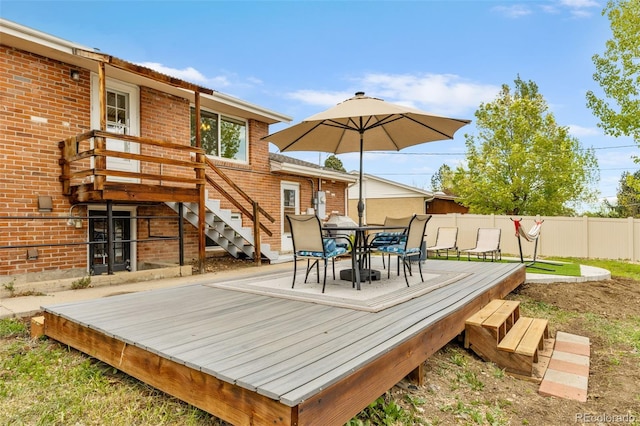 4544 W 65th Ave, Arvada, CO 80003 - wooden deck with outdoor dining area, fence, and stairs