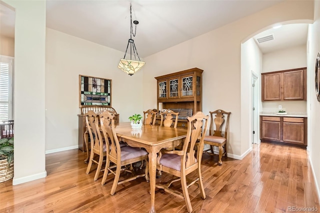 16550 Antero Cir, Broomfield, CO 80023 - dining space featuring arched walkways, light wood-style floors, and baseboards