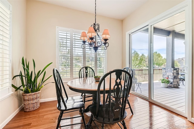 16550 Antero Cir, Broomfield, CO 80023 - dining room featuring a chandelier, wood finished floors, and baseboards