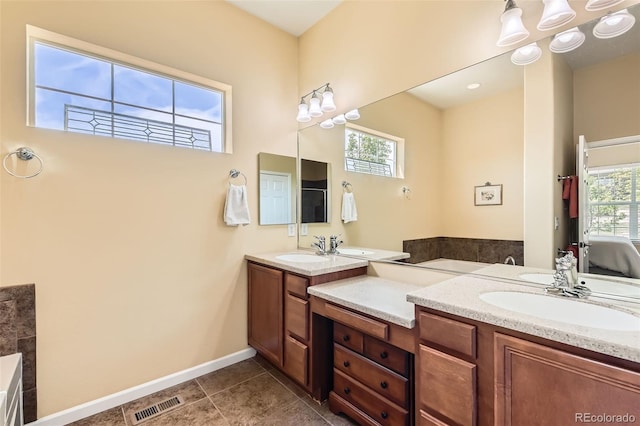 16550 Antero Cir, Broomfield, CO 80023 - full bathroom featuring double vanity, tile patterned floors, baseboards, and a bath