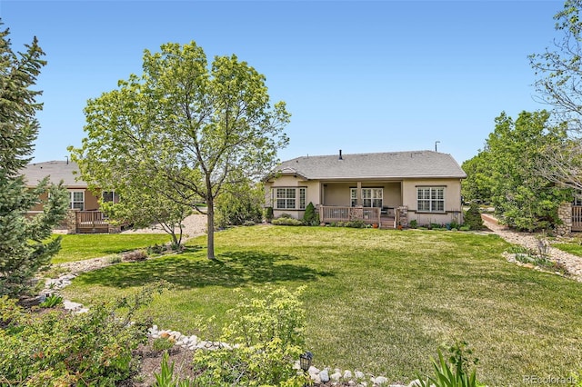 16550 Antero Cir, Broomfield, CO 80023 - view of front of home with stucco siding, a deck, and a front yard
