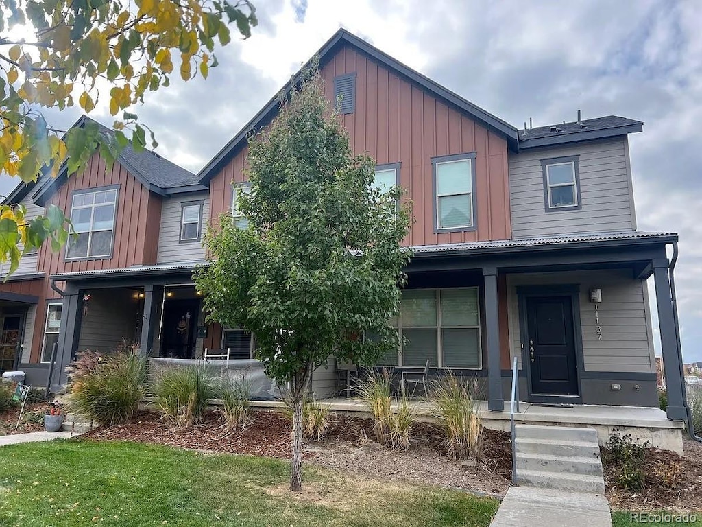 11137 E 25th Ave, Aurora, CO 80010 - view of front facade featuring a porch and board and batten siding