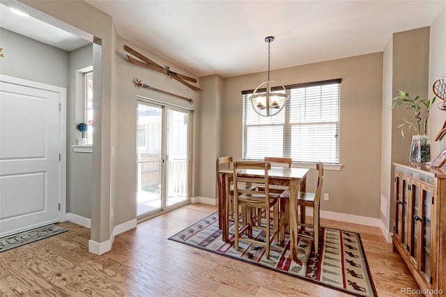 13713 Raritan Ln, Broomfield, CO 80023 - dining space featuring light wood-style floors and a chandelier