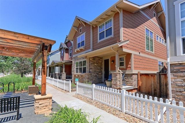 13713 Raritan Ln, Broomfield, CO 80023 - view of front of property featuring stone siding, a pergola, and covered porch