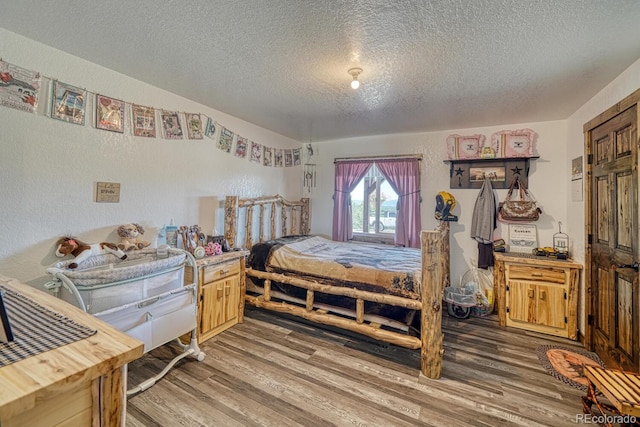 1625 Black Cloud Cir, Westcliffe, CO 81252 - bedroom featuring a textured ceiling and wood finished floors