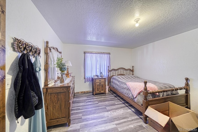 1625 Black Cloud Cir, Westcliffe, CO 81252 - bedroom with a textured ceiling and light wood-style floors