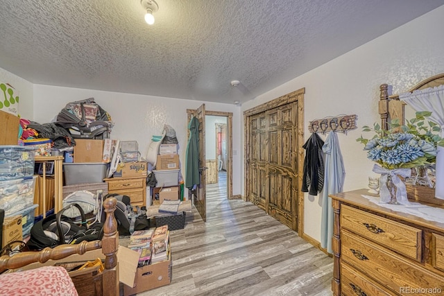 1625 Black Cloud Cir, Westcliffe, CO 81252 - bedroom featuring a textured ceiling, light wood-type flooring, and a closet