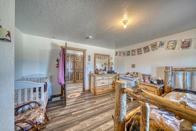 1625 Black Cloud Cir, Westcliffe, CO 81252 - bedroom featuring a textured ceiling and wood finished floors