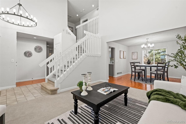 living room featuring light hardwood / wood-style floors and an inviting chandelier