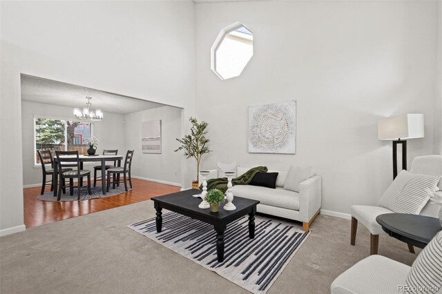 living room with hardwood / wood-style flooring and an inviting chandelier