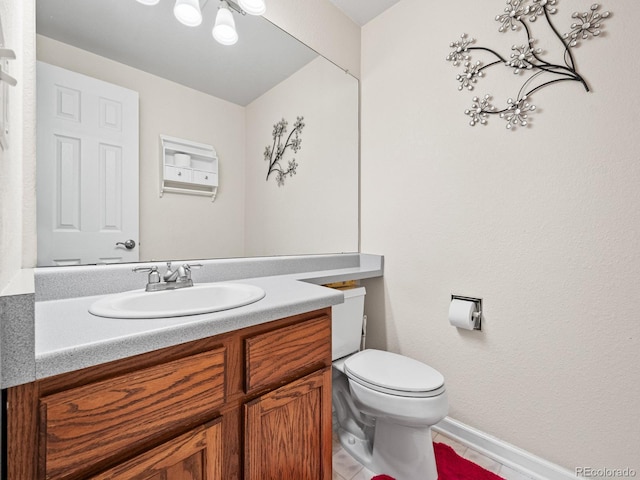 bathroom with tile patterned floors, vanity, and toilet