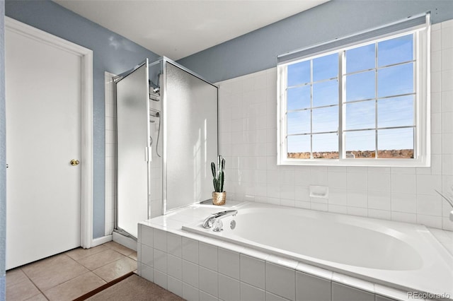 bathroom with tile patterned floors and separate shower and tub