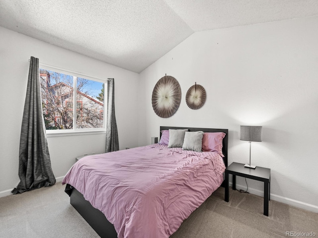 carpeted bedroom with a textured ceiling and lofted ceiling