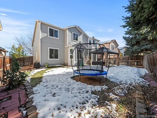 snow covered property with a trampoline