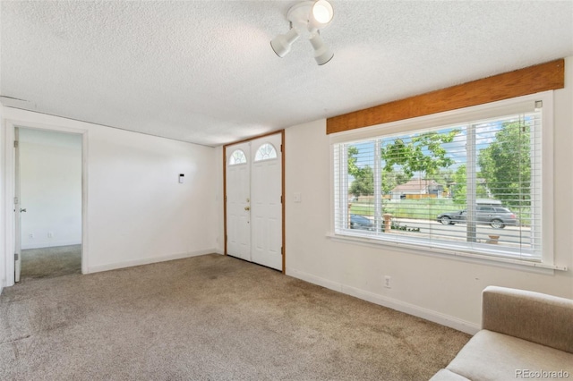 1175 Xanthia, Denver, CO 80220 - carpeted entryway featuring a textured ceiling and baseboards