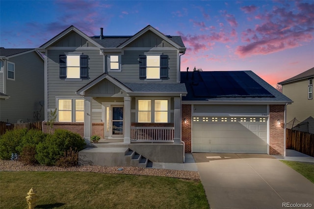 view of front facade with roof mounted solar panels, brick siding, board and batten siding, and covered porch