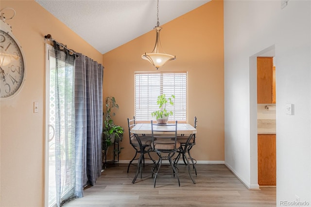 9563 Milwaukee Ct, Thornton, CO 80229 - dining room with light wood-type flooring and high vaulted ceiling