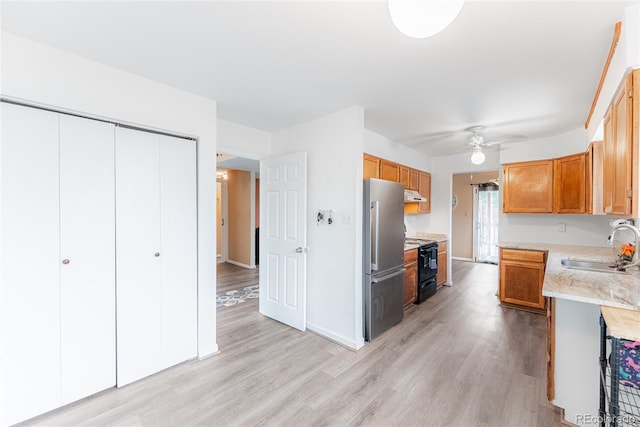 9563 Milwaukee Ct, Thornton, CO 80229 - kitchen with freestanding refrigerator, a ceiling fan, under cabinet range hood, light wood-type flooring, and black range with electric cooktop
