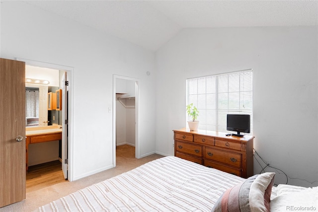 9563 Milwaukee Ct, Thornton, CO 80229 - bedroom with light colored carpet, a spacious closet, lofted ceiling, ensuite bathroom, and a closet
