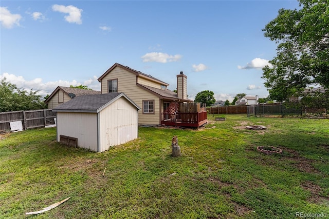 9563 Milwaukee Ct, Thornton, CO 80229 - rear view of property with a storage unit, a deck, a fenced backyard, and a fire pit
