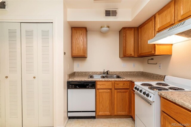 kitchen featuring light tile patterned flooring, white appliances, and sink