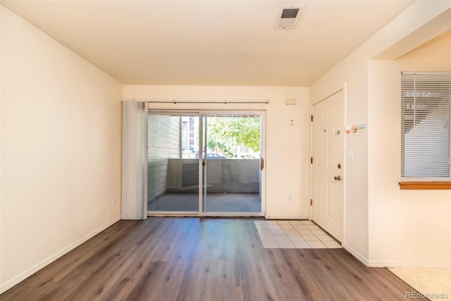 spare room with hardwood / wood-style floors