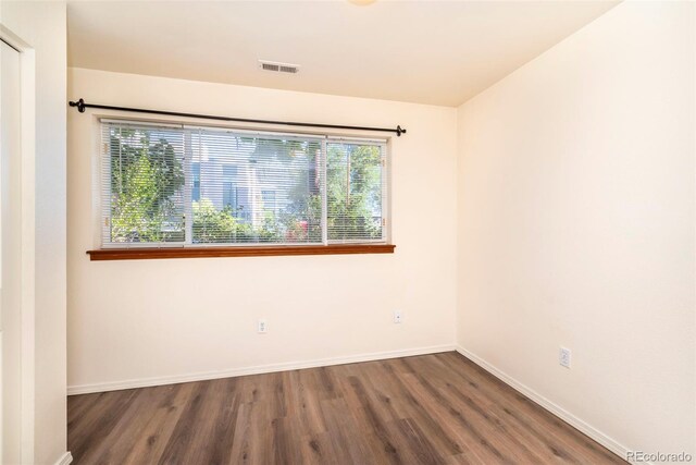 spare room with dark hardwood / wood-style flooring