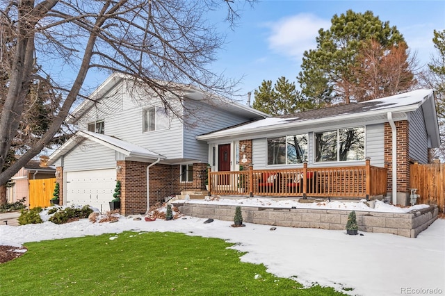 tri-level home featuring a lawn and a garage