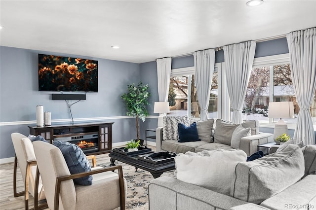 living room featuring a healthy amount of sunlight and hardwood / wood-style flooring