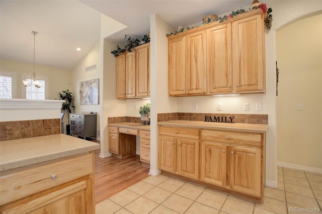 kitchen with light tile patterned flooring, light brown cabinets, visible vents, light countertops, and hanging light fixtures