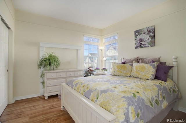 bedroom featuring baseboards and wood finished floors