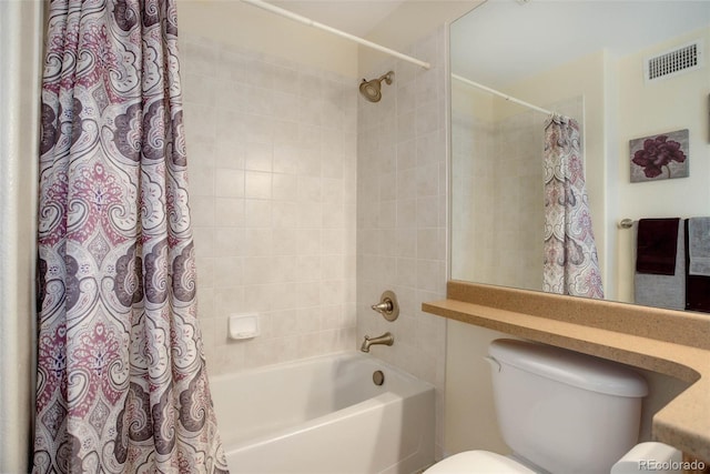 bathroom featuring shower / bath combo, visible vents, and toilet