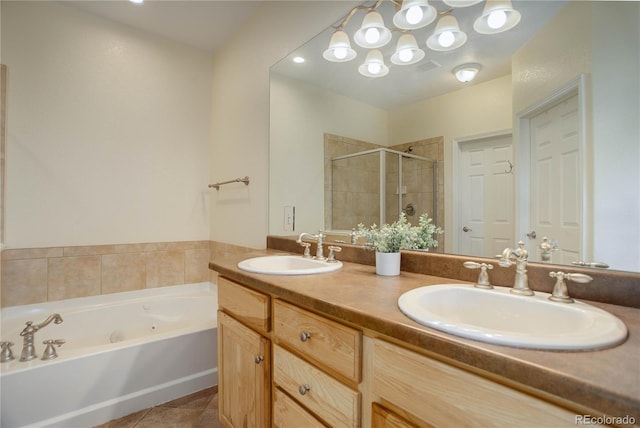 full bath with double vanity, a sink, a shower stall, and tile patterned floors