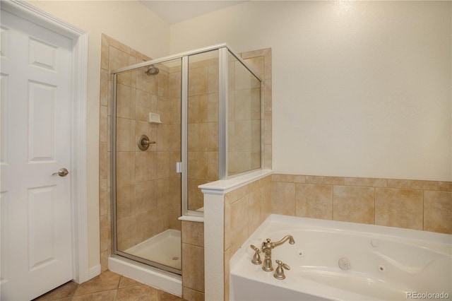 full bathroom with a jetted tub, a shower stall, and tile patterned floors