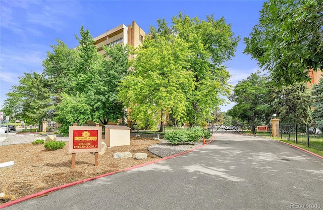 8060 E Girard Ave Unit 514, Denver, CO 80231 - view of asphalt road featuring curbs and a gated entry