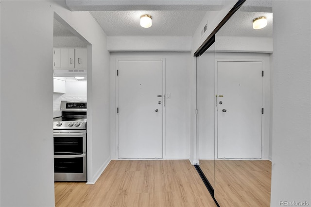 8060 E Girard Ave Unit 514, Denver, CO 80231 - entrance foyer featuring light wood-style flooring and a textured ceiling