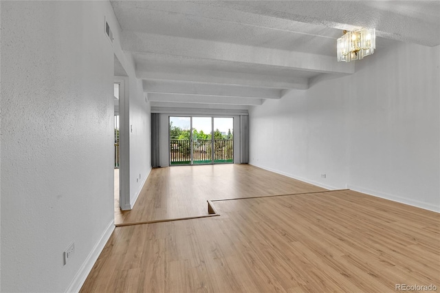 8060 E Girard Ave Unit 514, Denver, CO 80231 - empty room with wood finished floors, a chandelier, beam ceiling, and a textured ceiling