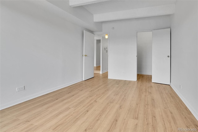 8060 E Girard Ave Unit 514, Denver, CO 80231 - unfurnished bedroom with light wood-style flooring and beamed ceiling