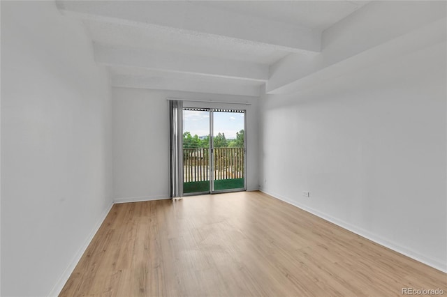 8060 E Girard Ave Unit 514, Denver, CO 80231 - empty room with light wood-style flooring and beamed ceiling